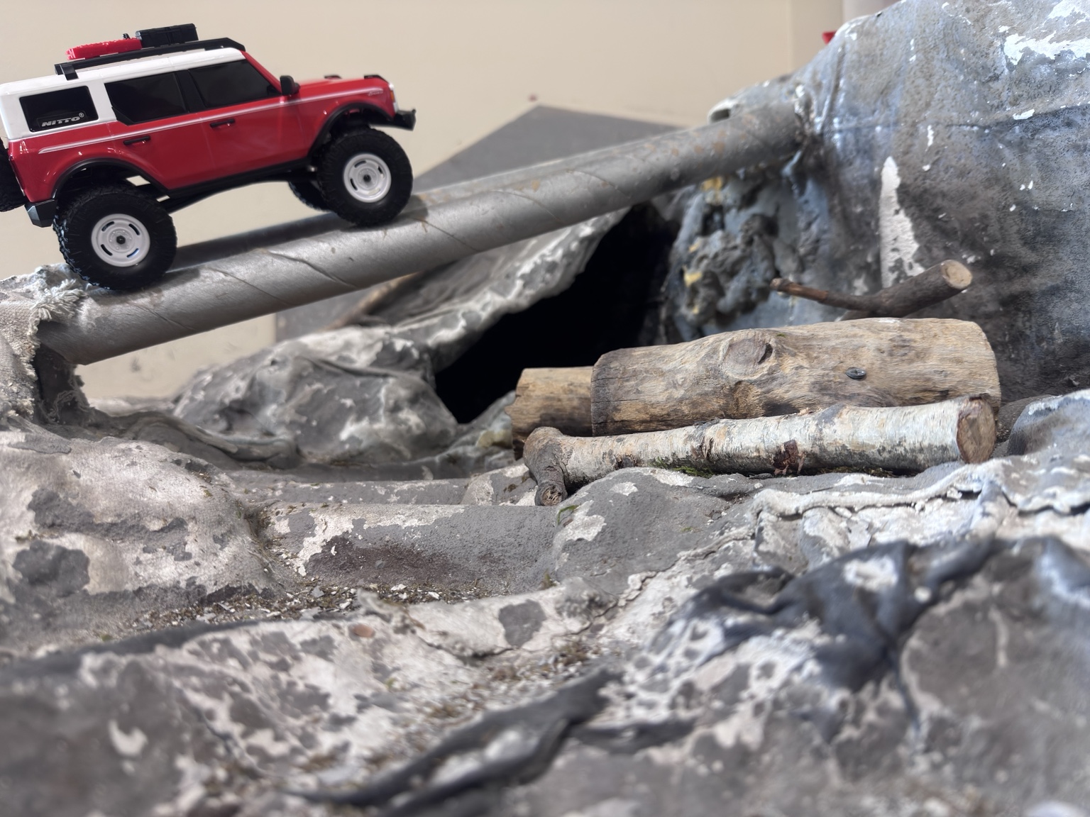 Small-scale RC crawler crossing logs on the Indy RC crawler course