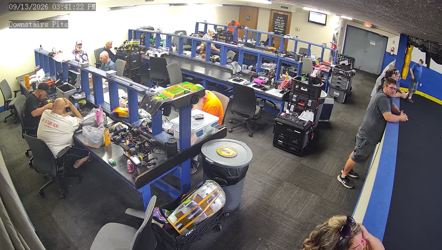 Racers working at the provided powered pit tables